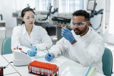 Two scientists examining a vial 